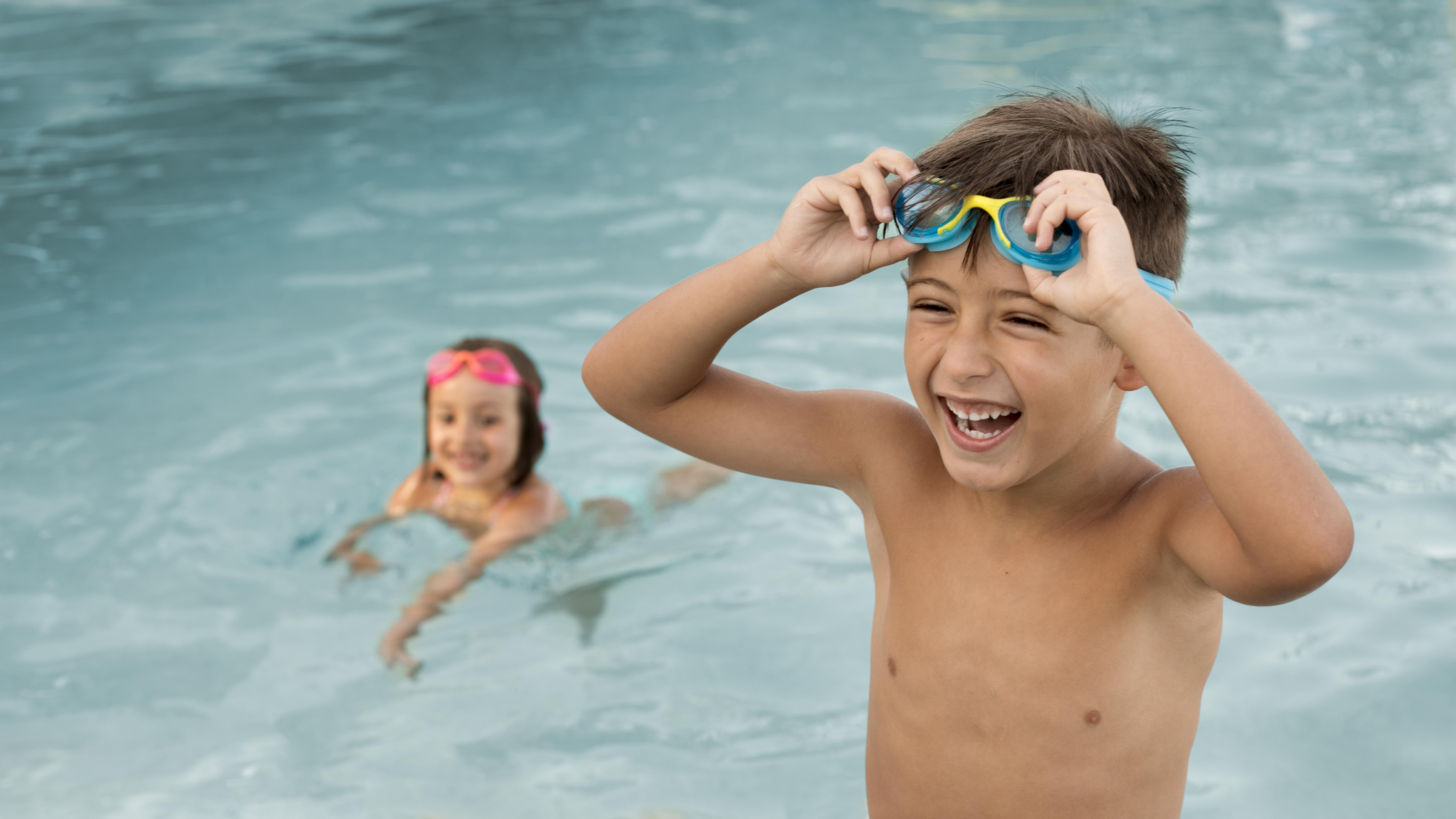 Children learning swimming technique with certified instructor Frank Romani